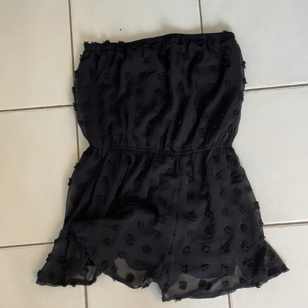 Black romper with pom poms
